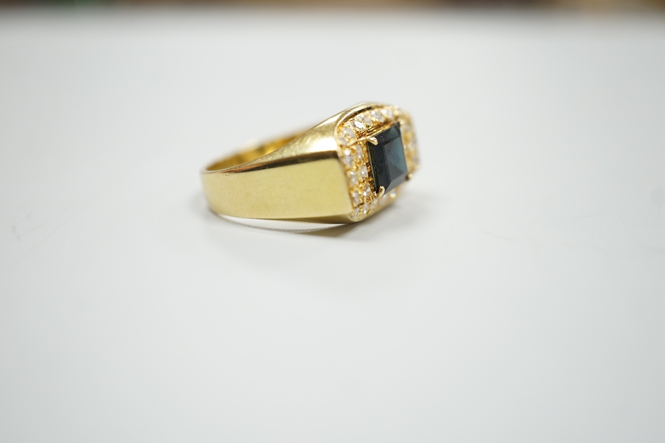 A modern 750 yellow metal, single stone sapphire and pave set diamond dress ring, size O, gross weight 5.9 grams.